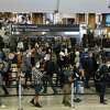 People wind their way in a queue line created by stanchions at a security checkpoint at San Francisco International Airport on Wednesday.