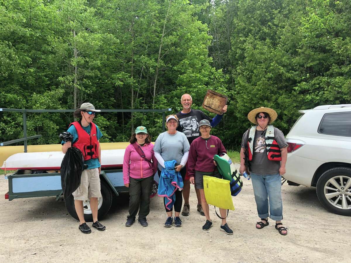 Volunteers with the Benzie Conservation District help clean up the Betsie River during the Betsie River Clean Sweep.