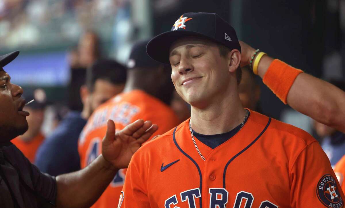 Phil Maton of the Houston Astros celebrates with teammates after throwing just nine pitches to retire the side against the Texas Rangers in the seventh inning at Globe Life Field on June 15, 2022 in Arlington, Texas.