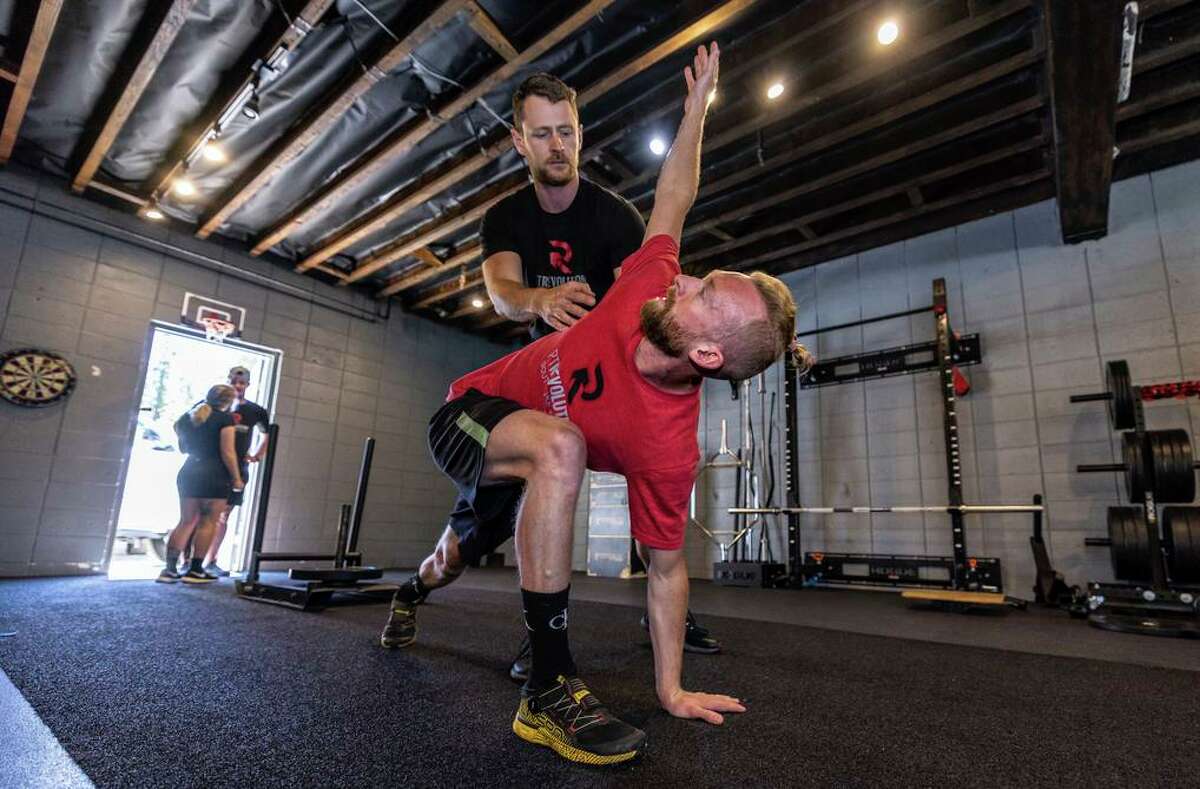 Physical Therapist Ian Anderson of PT Revolution perfects the warmup of professional snowboarder Brian Stenerson.