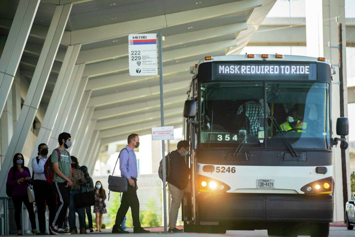 Commuters line up to board the Route 222 Metropolitan Transit Authority bus to downtown at the Grand Parkway park and ride, Thursday, April 14, 2022, in Katy.