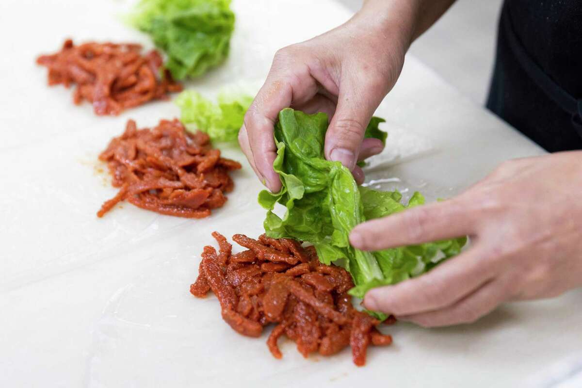 Preparing vegan char siu pork summer rolls at Lee’s Sandwiches in San Jose.