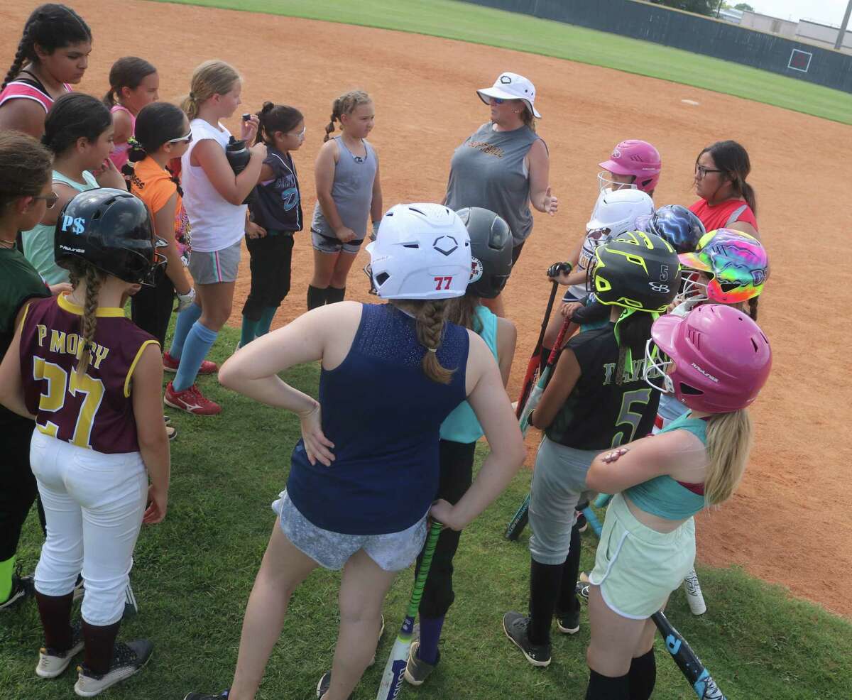 Deer Park softball head coach Amy Vidal, just 12 days removed from standing on UT's softball field in Austin, provides some instruction for the campers Wednesday.