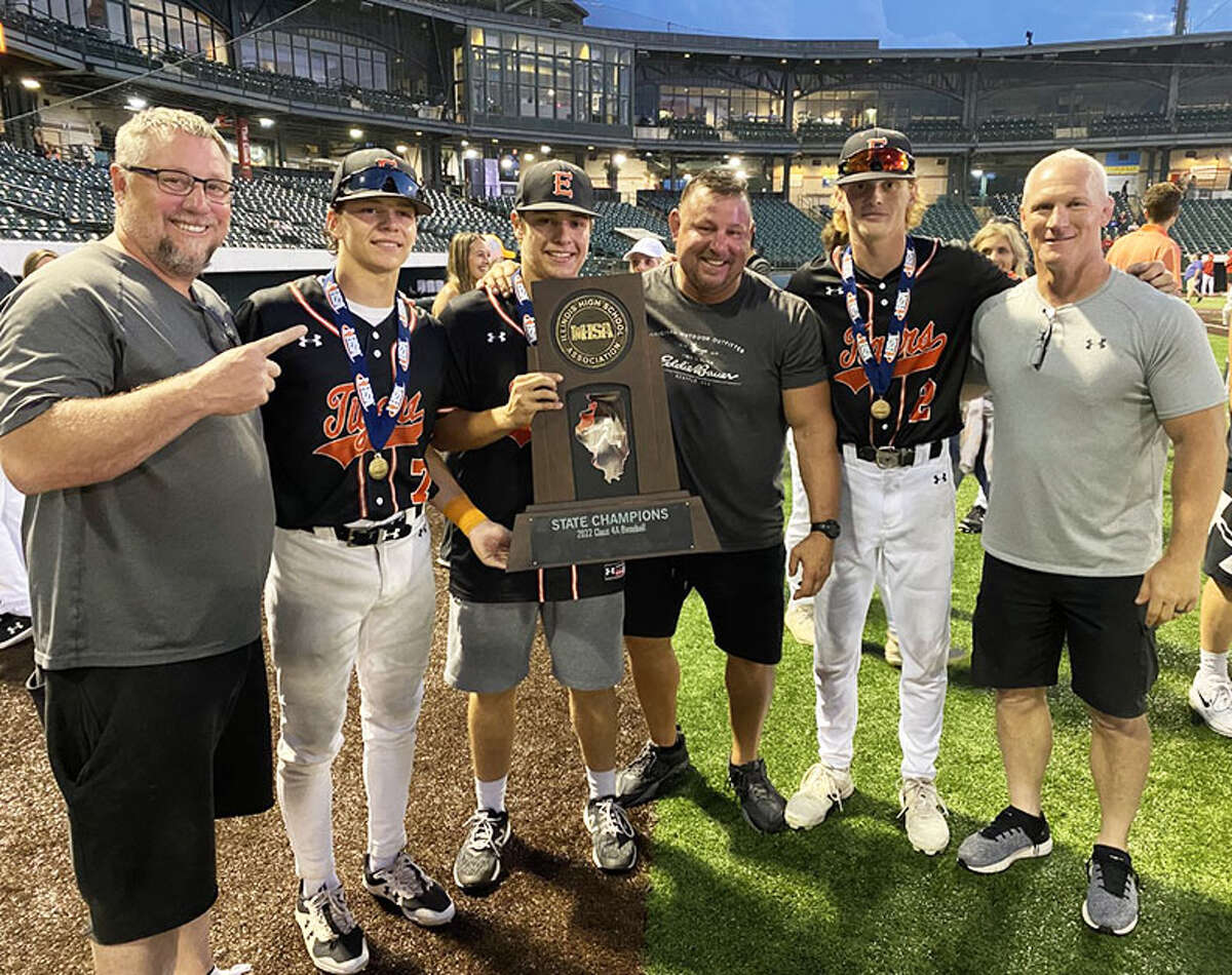 From left, Jon Hardy and son Cade, Caeleb Copeland and dad Brad, and Jacoby Roberson and dad Eric pose with the Class 4A baseball state championship trophy on Saturday night in Joliet.