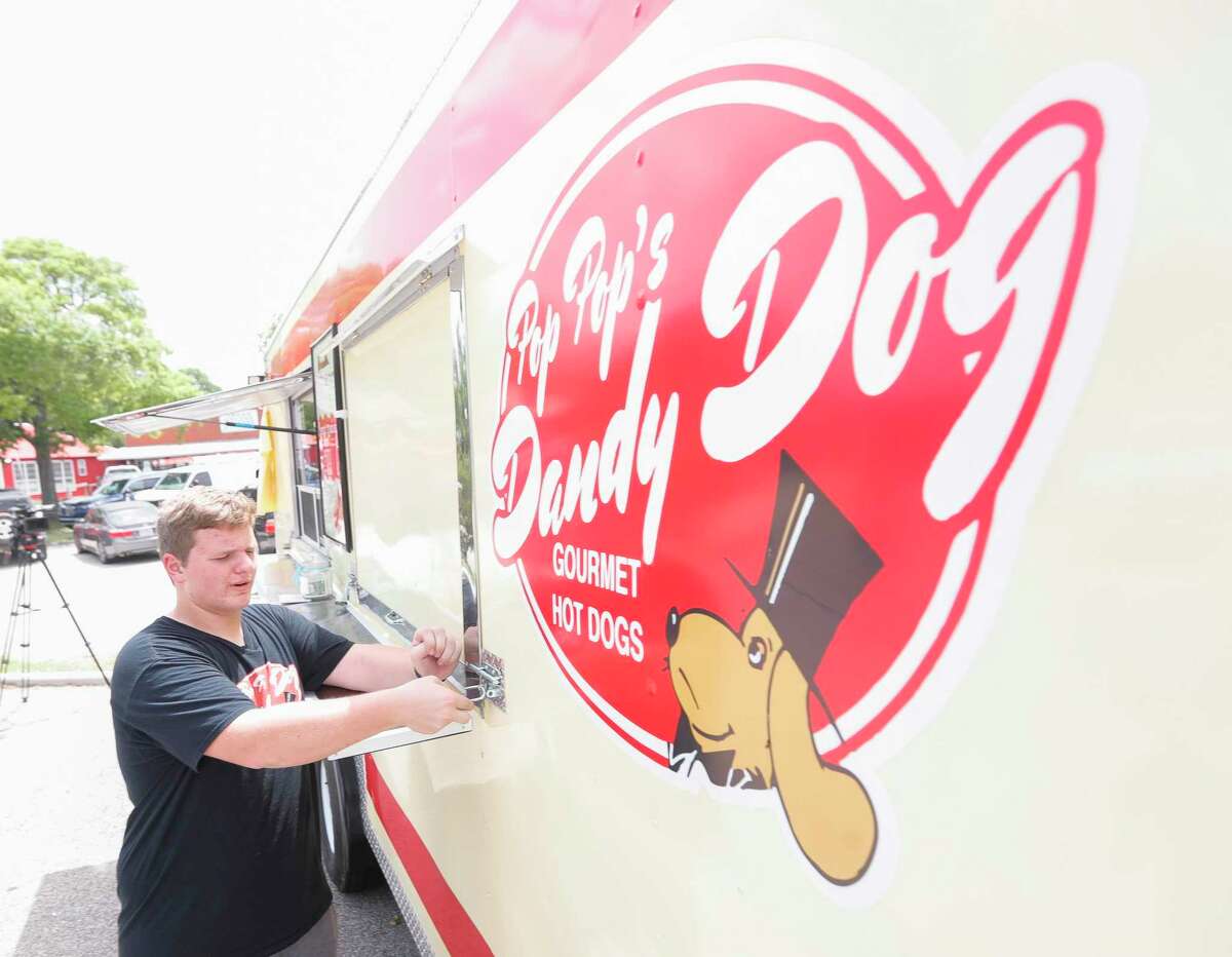 Jacob Irding prepares to open his food truck, Pop Pop’s Dandy Dogs, Tuesday, June, 14, 2022, in Montgomery. The 16-year-old Lake Creek High School student opened the truck on June 11 in downtown Montgomery.