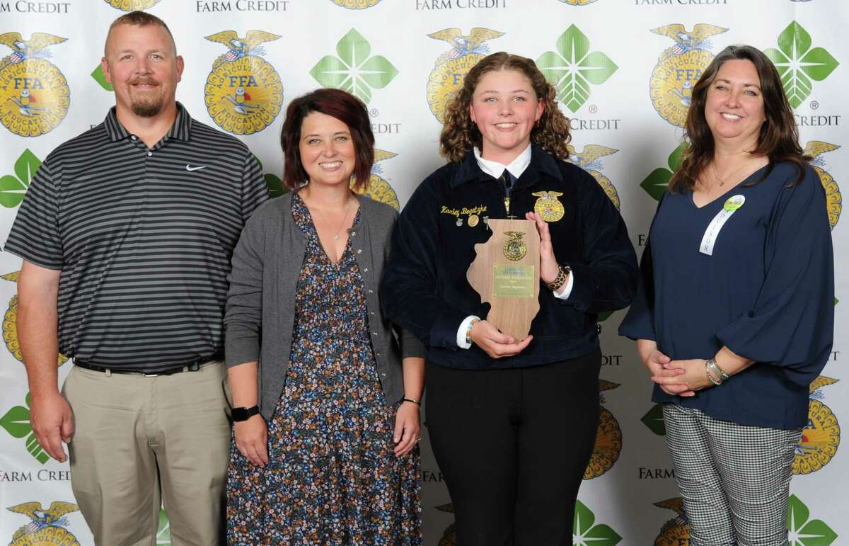 Pittsfield FFA member Karley Bogatzke (center right) picked up the State FFA Award for Outdoor Recreation during the 94th annual Illinois FFA State Convention. Six west-central Illinois FFA chapters received recognition at the event.
