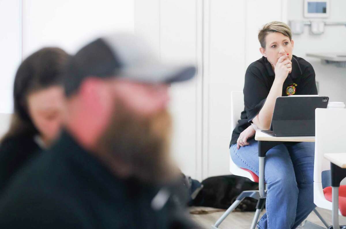 Veteran Marcey Phillips listens as John Barkley present on the challenges of starting a small business during a veteran entrepreneur book camp at the Conroe University of St. Thomas MAX Center, Saturday, Feb. 12, 2022, in Conroe.