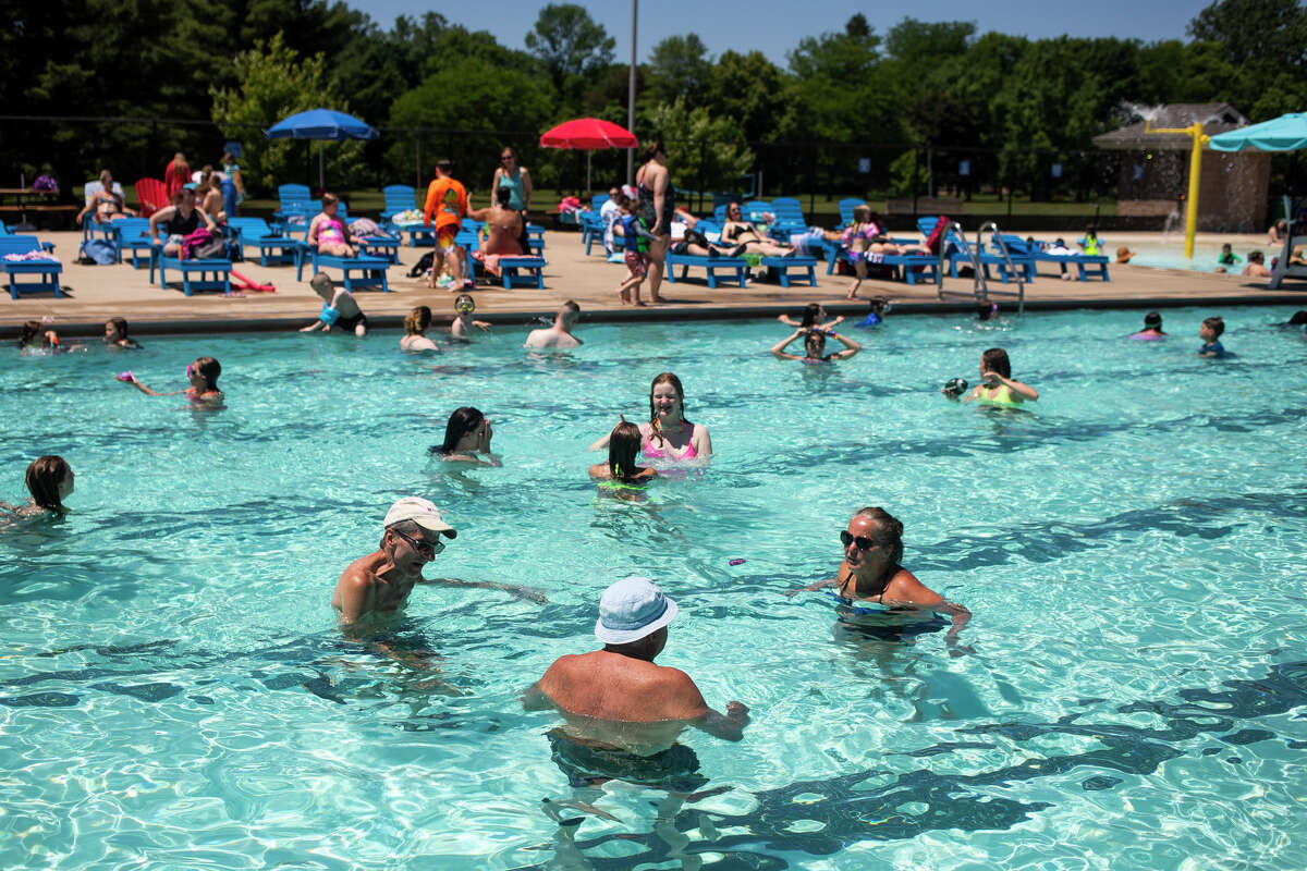 Families cool off from temperatures in the high 80s at Plymouth Pool Thursday, June 16, 2022 in Midland.