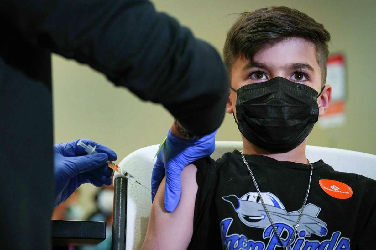 Charlie French, 8, receives a Pfizer-BioNTech COVID-19 booster vaccine during a vaccination clinic at Texas Children’s Hospital Friday, May 20, 2022 in Houston.