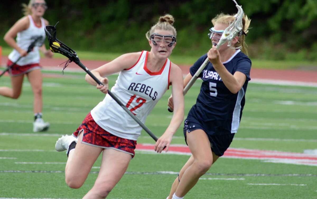 Madelyn Breitbeil of New Fairfield carries the ball downfield, while being defended by Charlotte Michener of Lauralton Hall during the Class S girls lacrosse championship on Saturday, June 11, 2022 at Sacred Heart University in Fairfield, Conn.