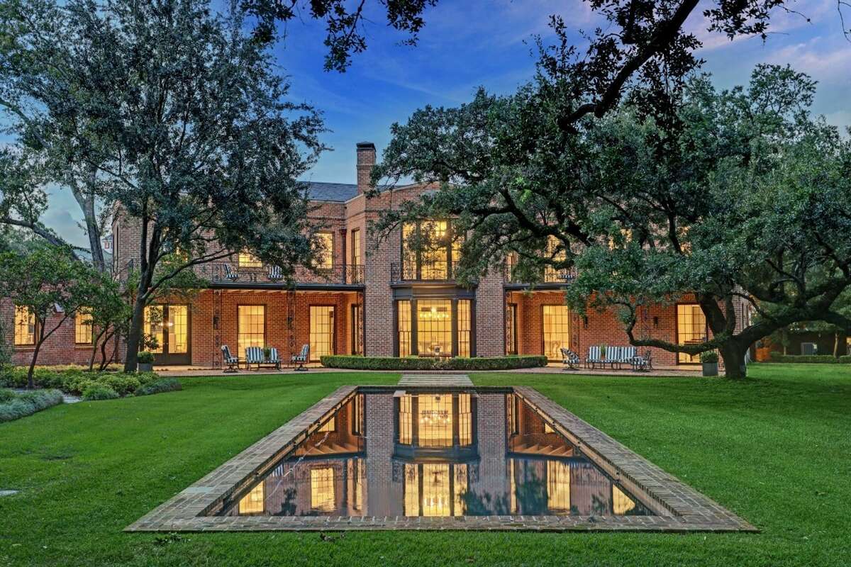 The home sits 1.36 acres, which includes brick patios, gardens, fountains, heritage trees and pool set into the lawn.