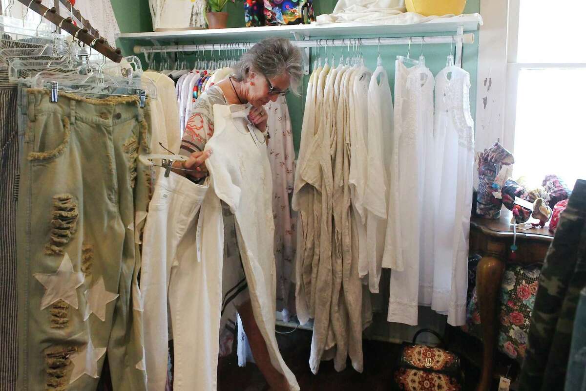 The community is invited to dress in white for the inaugural event, in which participants will stroll through the streets from 4-8 p.m. GingerSnaps boutique sales associate Kathy Madden shows examples of possible clothing participants could wear.