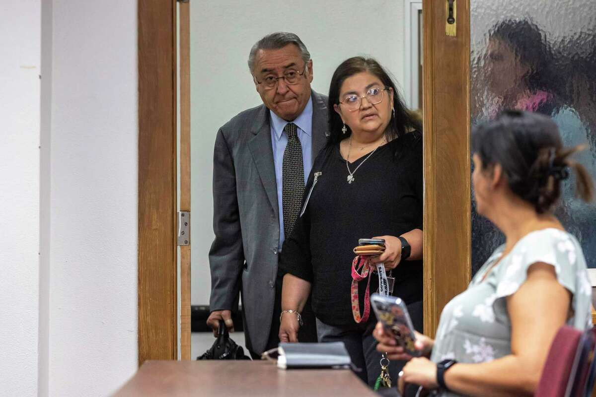 Robb Elementary School Prinicpal Mandy Gutierrez, right, and Attorney Ricardo G. Cedillo, left, peak into the room where a special House committee hearing on the massacre at Robb Elementary School is held at Uvalde City Hall in Uvalde, TX, on June 16, 2022. The committee will meet in Uvalde Thursday and Friday hear testimony from law enforcement authorities and others affected by the worst school shooting ever in Texas.