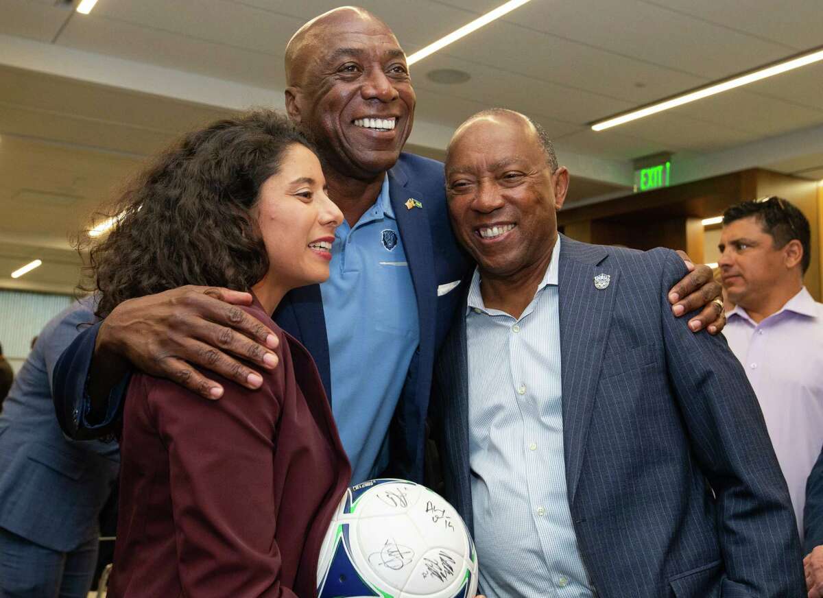 Lynden Rose, the Houston 2026 World Cup Bid Committee member, hugs Harris County Judge Lina Hidalgo, left, and Houston Mayor Sylvester Turner after FIFA announced Houston will be one of the hosting cities of 2026 World Cup Thursday, June 16, 2022, in Houston.