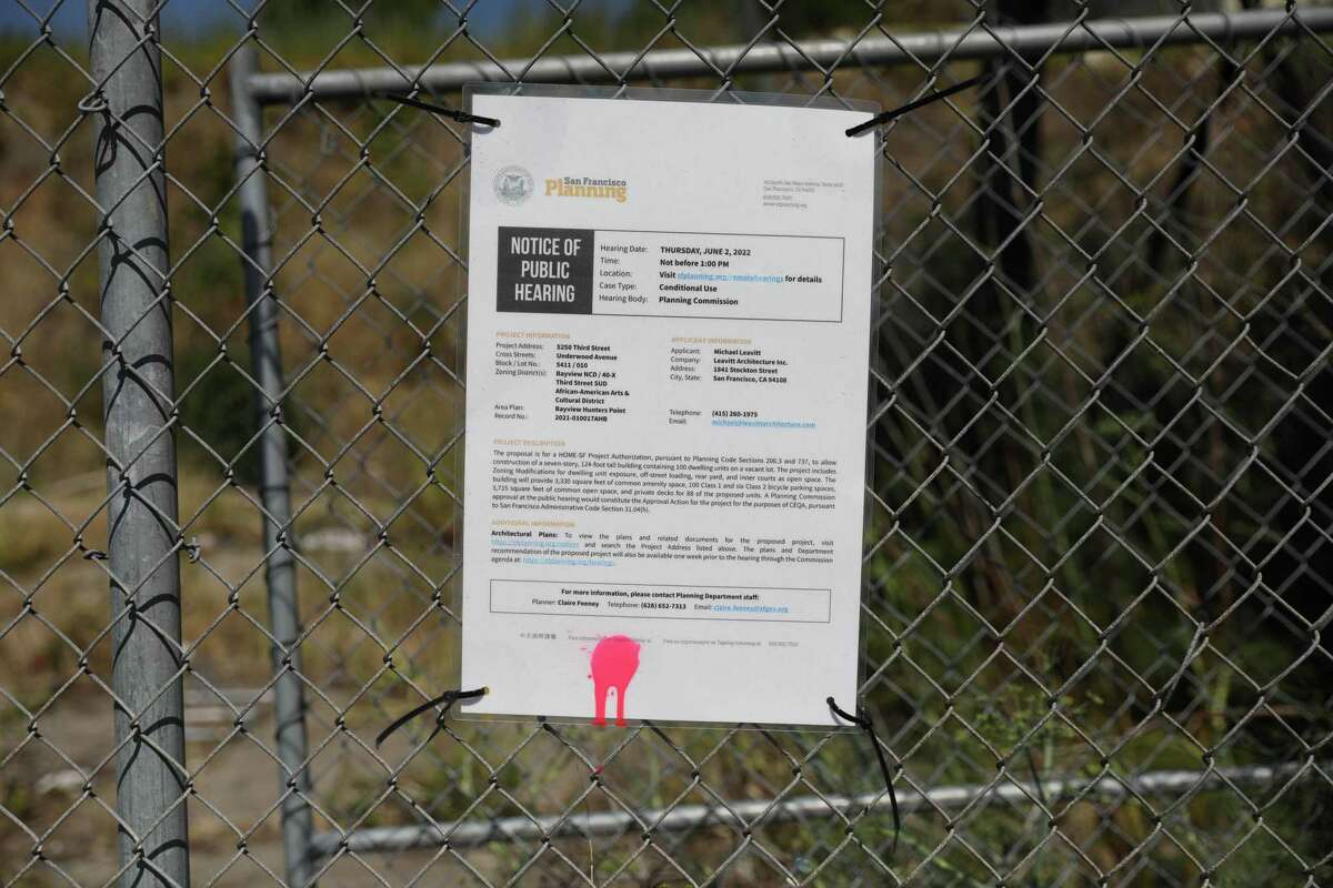 A notice for a past public hearing is seen on a fence on a site on Third Street that Tim Szarnicki and Joey Toboni are hoping to develop into affordable housing.