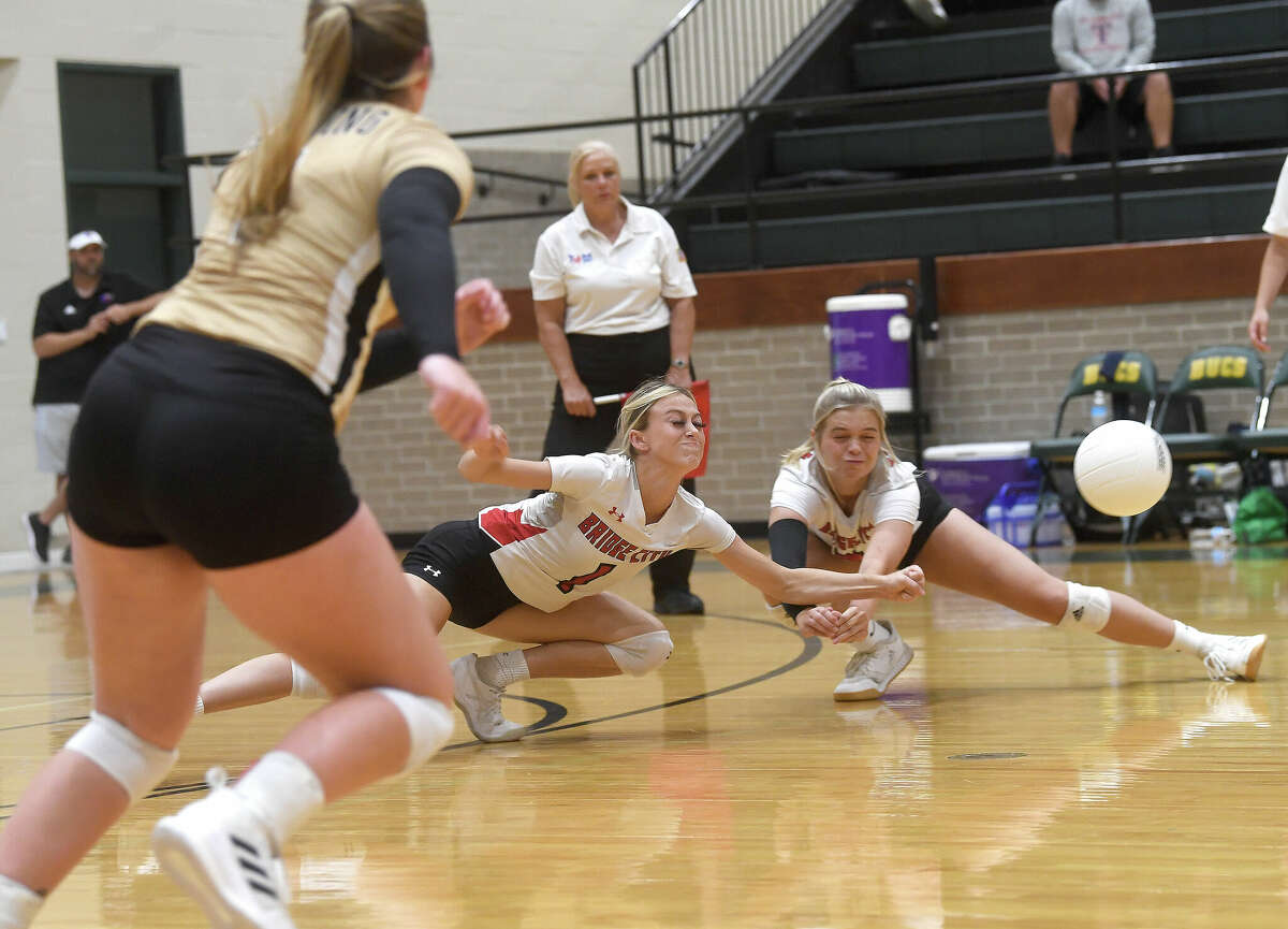 Team East's Caryss Carpenter and Harlee Tupper try to keep the ball alive during the Christus All-Star Classic volleyball game at East Chambers High School. Photo made Thursday, June 16, 2022. Kim Brent/The Enterprise