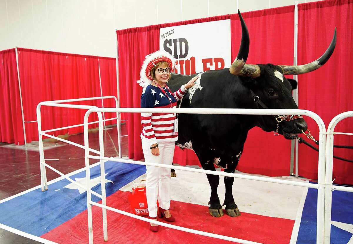 Elaine Wilmore, of Cleburne, poses for a photo with Tex on Thursday during the first day of the state GOP convention.