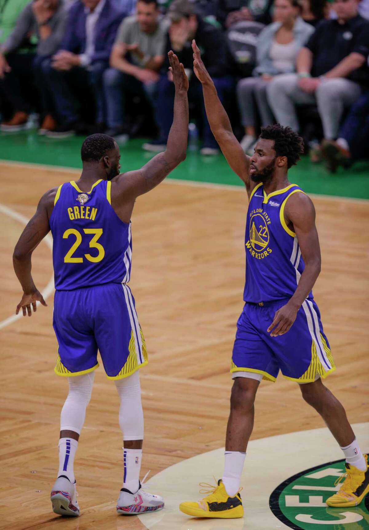 Golden State Warriors' Draymond Green, 23, gives Andrew Wiggins, 22, a high five during the second quarter in Game 6 of the NBA Finals at TD Garden in Boston, Mass., on Thursday, June 16, 2022.