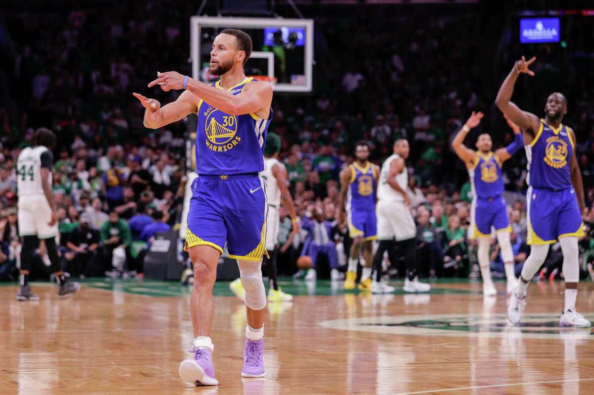 Golden State Warriors' Stephen Curry, 30, points to his ring finger as he walks up court during the third quarter in Game 6 of the NBA Finals at TD Garden in Boston, Mass., on Thursday, June 16, 2022.