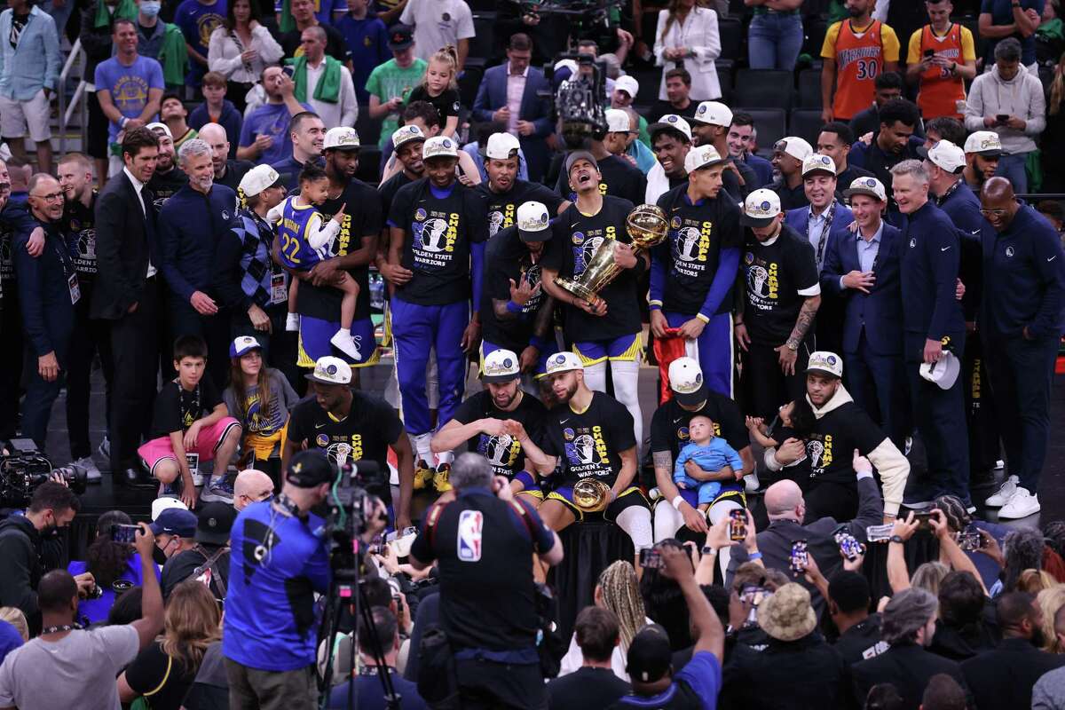 Golden State Warriors’ Jordan Poole holds the Larry O’Brien Trophy as the Warriors pose for a group photo after winning NBA Championship after a 103-90 win over Boston Celtics in Game 6 of NBA Finals at TD Garden in Boston Mass., on Thursday, June 16, 2022.