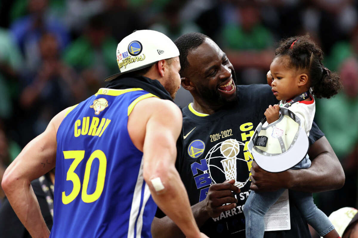 Stephen Curry #30 of the Golden State Warriors celebrates with Draymond Green and his daughter Kyla Green after defeating the Boston Celtics 103-90 in Game 6 of the 2022 NBA Finals at TD Garden on June 16, 2022.