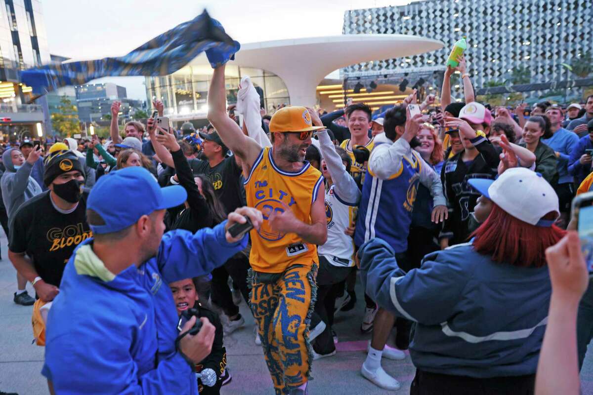 People celebrate after the Golden State Warriors win the NBA Finals, Thursday, June 16, 2022, in San Francisco, Calif. Chase Center hosted the watch party for Game 6 between the Golden State Warriors and Boston Celtics televised on their arena scoreboard as well as outdoors at Thrive City's digital display.