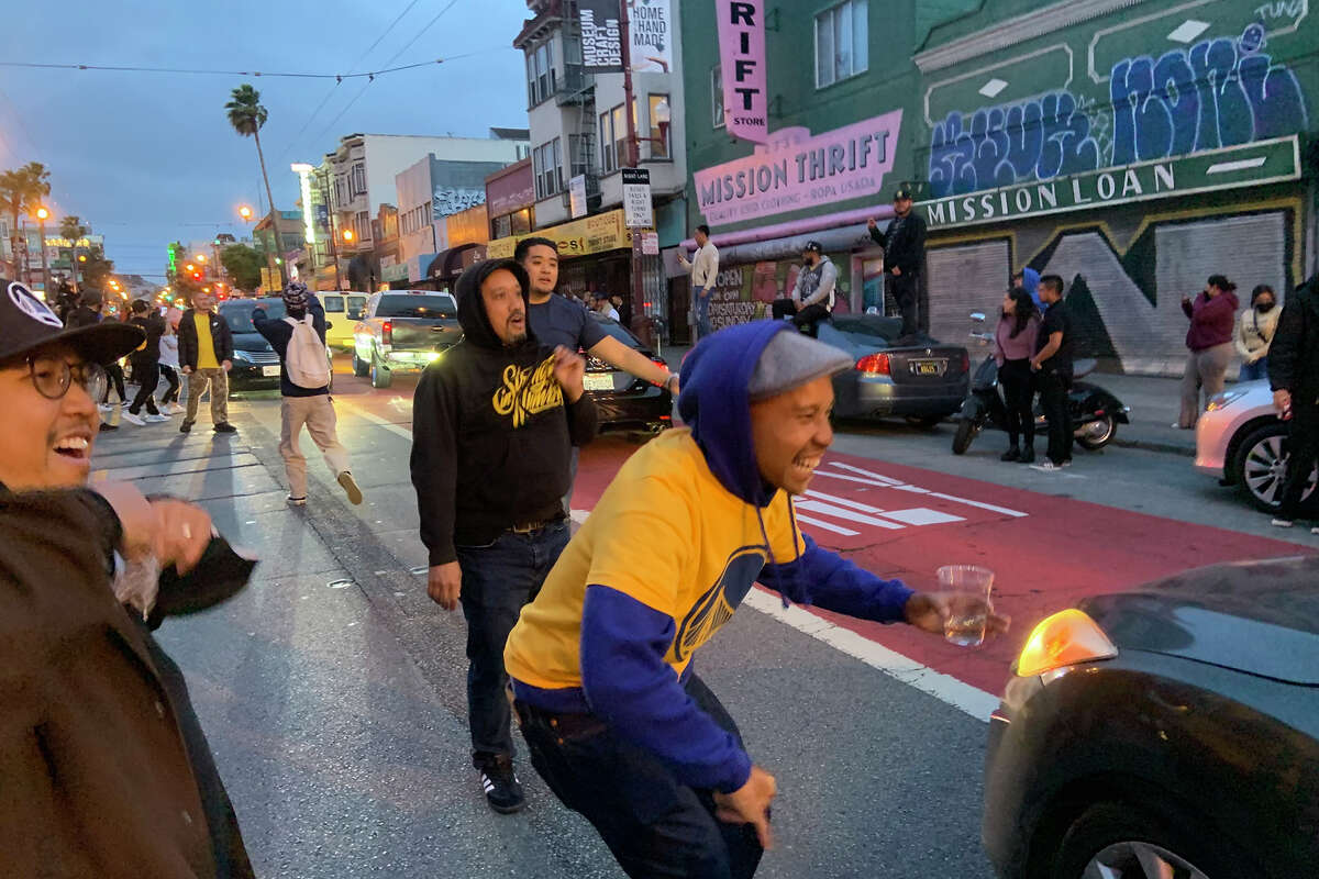 Warriors fans celebrate on Mission Street amid traffic shortly after the team's victory in the NBA finals, on Thursday, June 16, 2022.