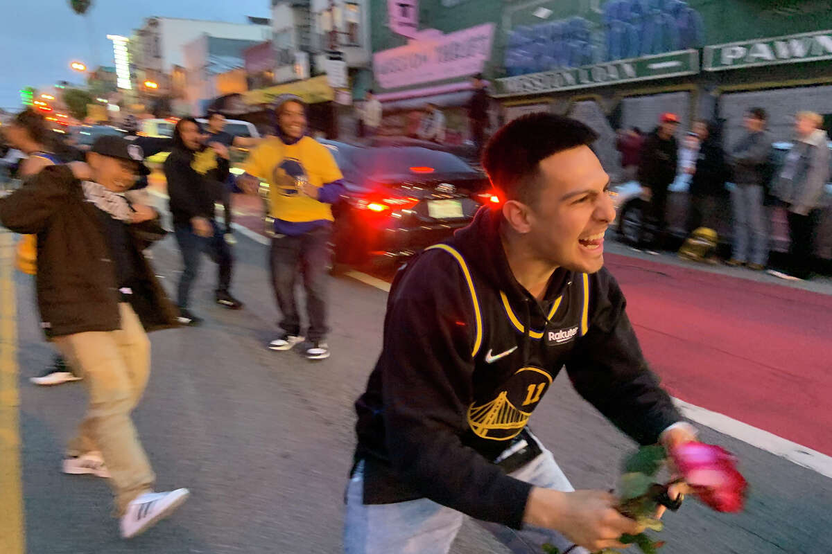 Warriors fans celebrate on Mission Street amid traffic shortly after the team's victory in the NBA finals, on Thursday, June 16, 2022.