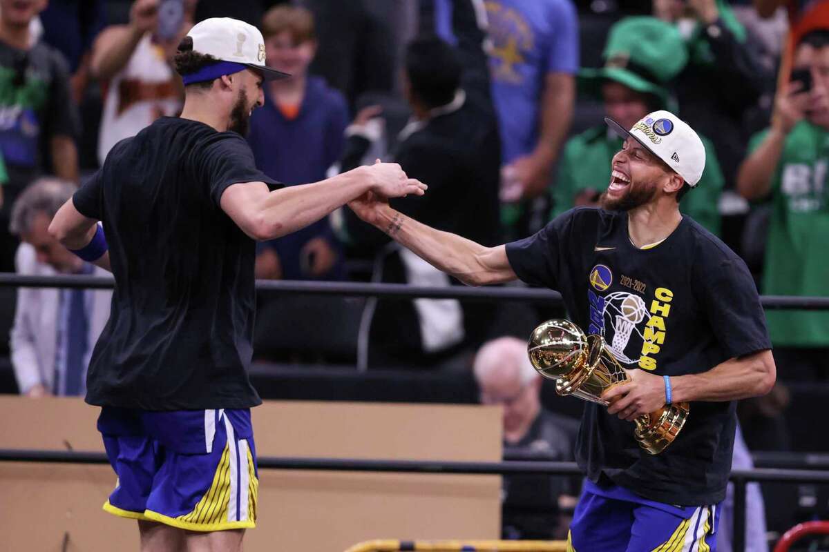 Golden State Warriors' Klay Thompson, 11, and Stephen Curry, 30, dance on stage after the Golden State Warriors defeated the Boston Celtics 103 to 90 in Game 6 to win the NBA Finals at TD Garden in Boston, Mass., on Thursday, June 16, 2022.
