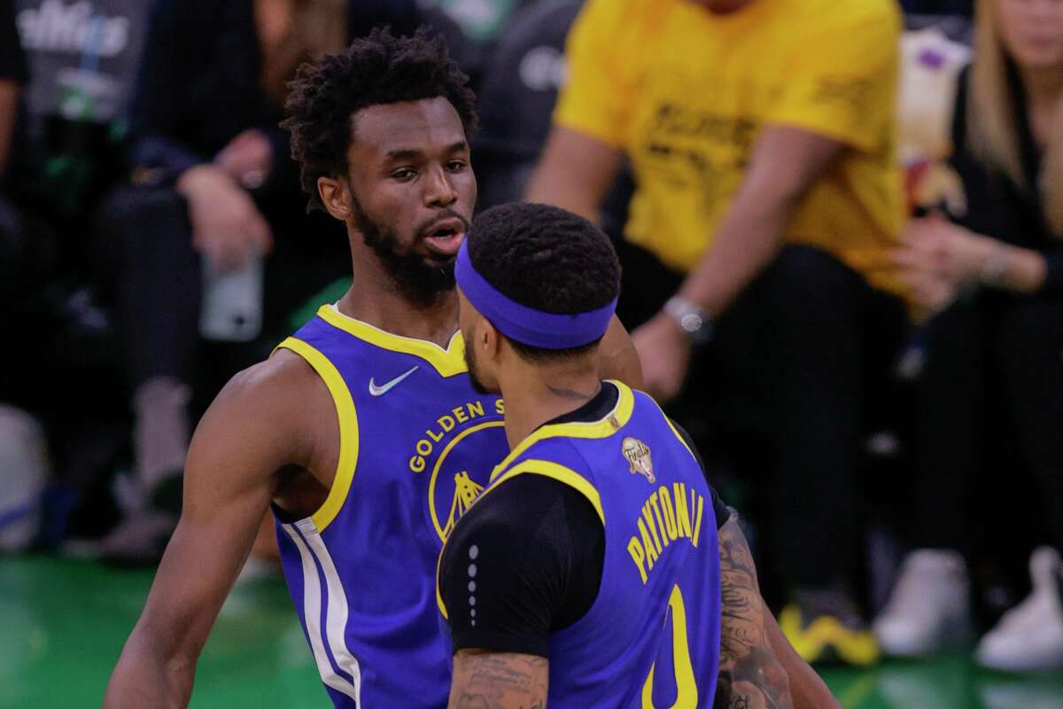 Golden State Warriors' Andrew Wiggins, 22, and Gary Payton II, 0, bump chests during the second quarter in Game 6 of the NBA Finals at TD Garden in Boston, Mass., on Thursday, June 16, 2022.