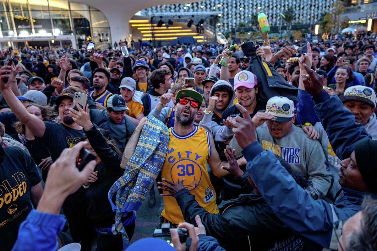 Fans celebrate outside the Chase Center shortly after the Warriors won the NBA finals, on Thursday June 16, 2022, in San Francisco.