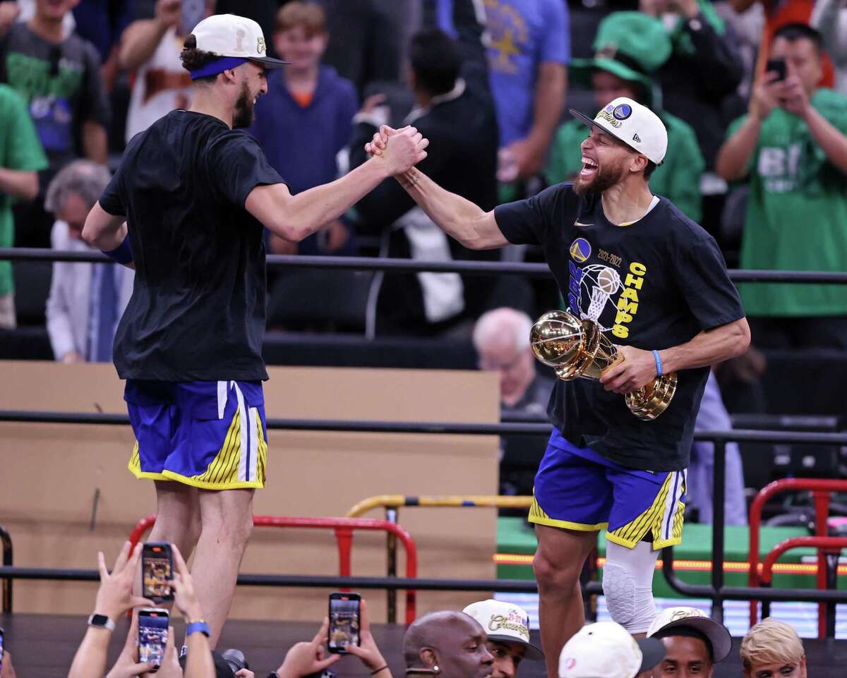 Golden State Warriors’ Stephen Curry and Klay Thompson dance on stage after winning NBA Championship after a 103-90 win over Boston Celtics in Game 6 of NBA Finals at TD Garden in Boston Mass., on Thursday, June 16, 2022.
