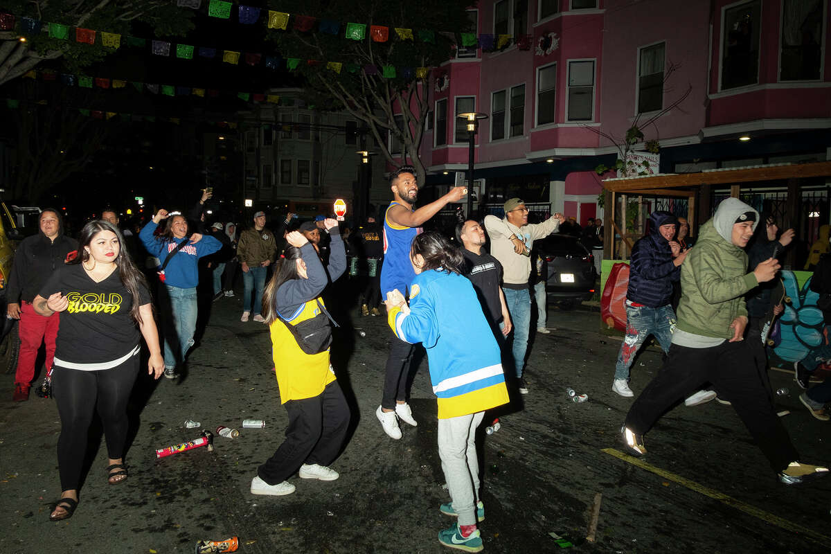 Warriors fans grow rowdy as police approach late in the evening on 24th Street in the Mission District, in the aftermath of the team's NBA finals championship, on Thursday, June 16, 2021.