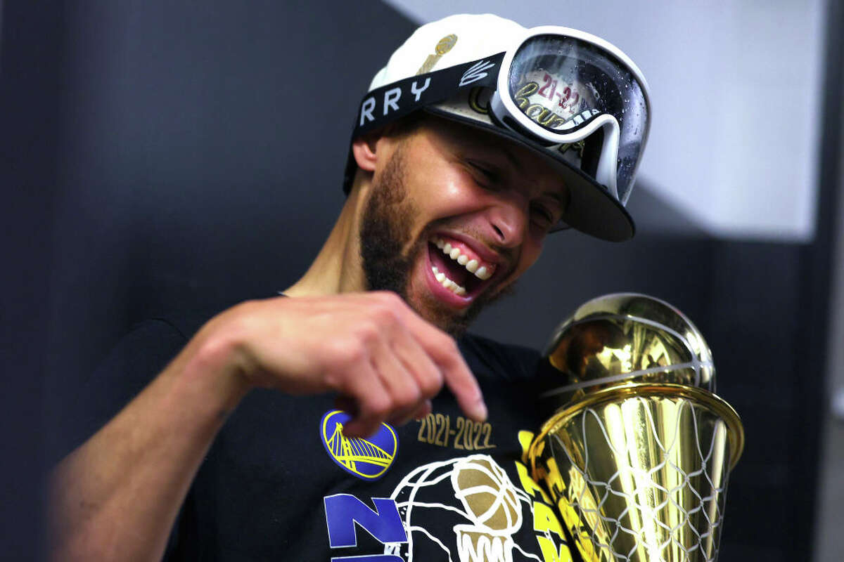 Golden State Warriors star Stephen Curry celebrates with the Bill Russell NBA Finals Most Valuable Player Award after defeating the Boston Celtics 103-90 at TD Garden on June 16, 2022 in Boston, Massachusetts.