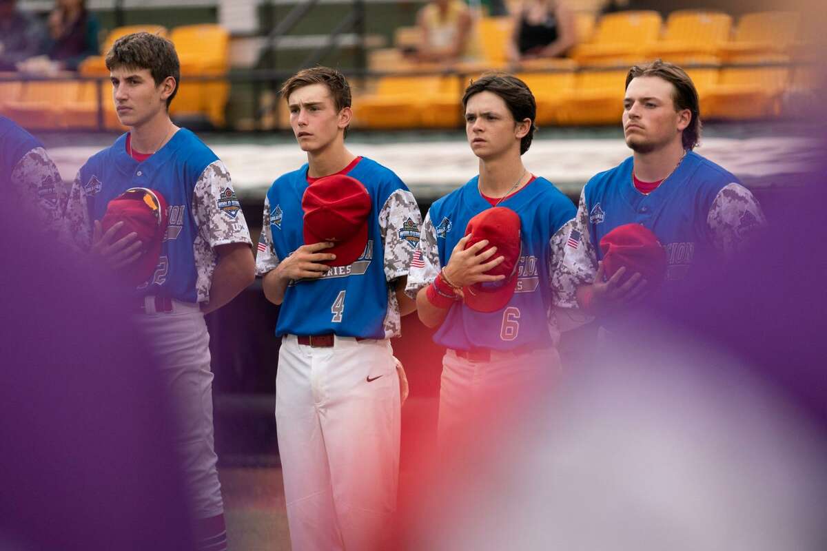 Berryhill's (from left) Lane Kloha, Brody Krzysiak, Nolan Sanders, and Braylen Laverty stand for the national anthem prior to an Aug. 14, 2021 American Legion Baseball World Series game vs. Beverly, Mass.
