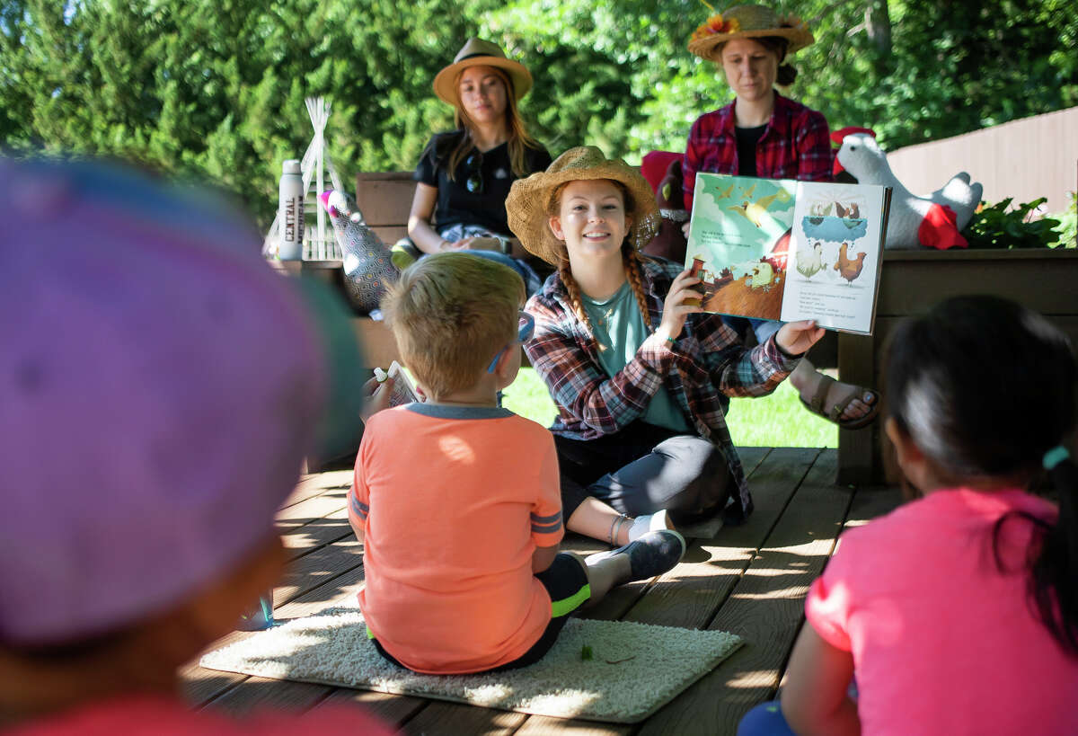 Maddie Snyder reads a book to a group of children during Storytime in the Children's Garden Friday, June 17, 2022 at Dow Gardens.