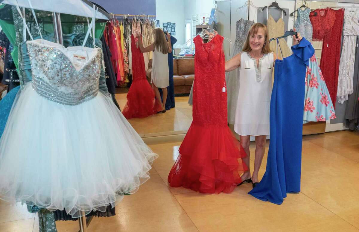 Debbie Hightower shows off some of the dresses she has available 06/17/2022 in The Party Trunk consignment shop. Tim Fischer/Reporter-Telegram
