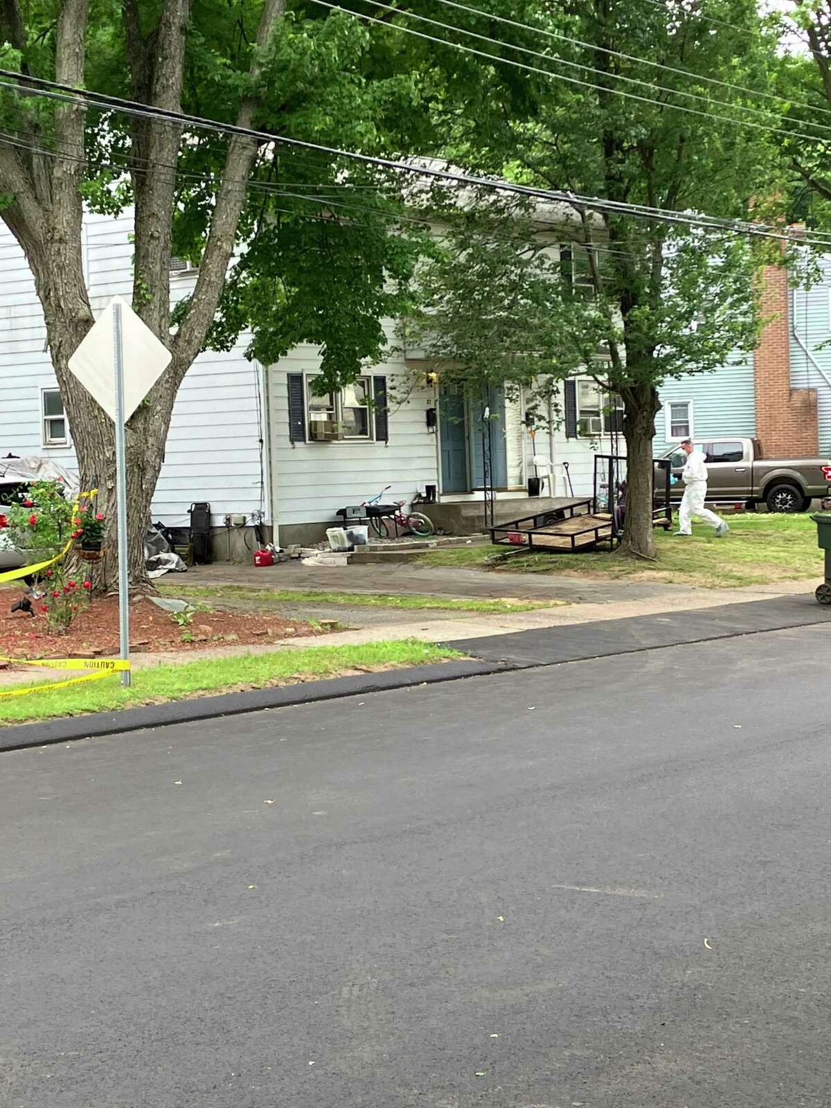 Police taped off an area Thursday, June 16, 2022 near a home on Graham Road in East Hartford where they said two people were shot during a home invasion. Both were later pronounced dead, according to police.