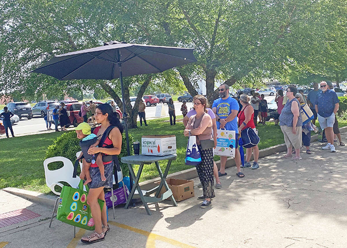 People line up for the free monthly food distribution on June 15 at Glen-Ed Pantry. Jane Ahasay, director of development for the pantry, said that 230 families were served, providing food to 580 people.