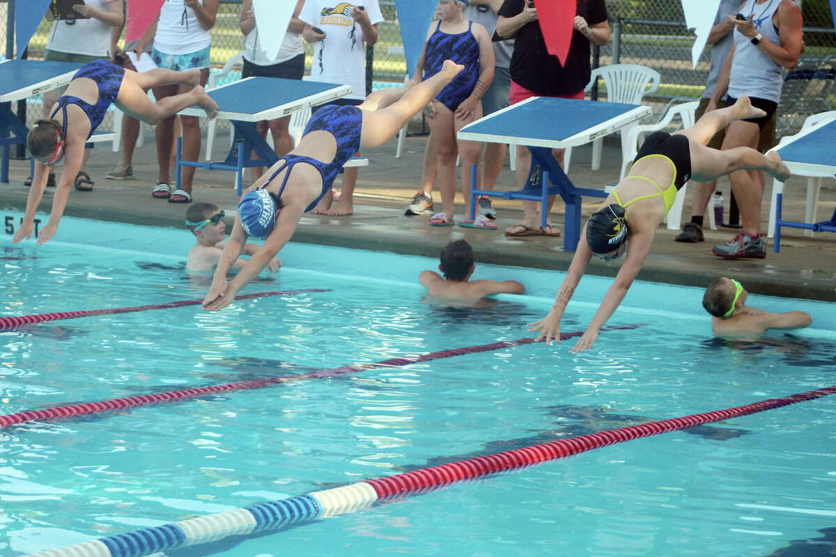 Swimmers fly off the starting blocks at the beginning of the 11-12 100 freestyle at Thursday's dual meet between Summers-Port and Sunset Hills in Godfrey.