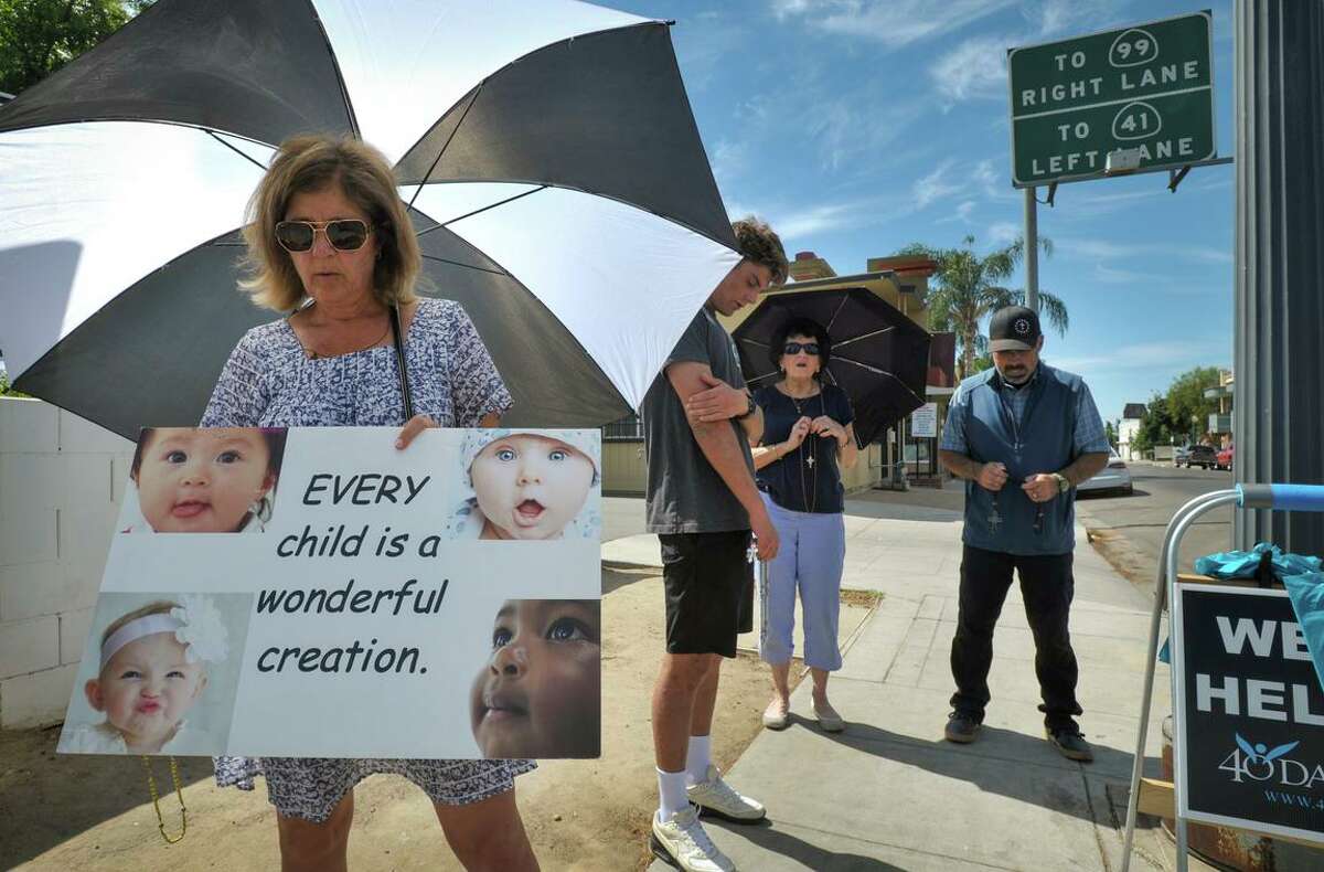 Antiabortion activists pray on the sidewalk between a Planned Parenthood clinic and the Right to Life outreach center in Fresno. The proximity of the clinic and the center belie a statistical imbalance: In California, there are more antiabortion “crisis pregnancy centers” than there are abortion clinics.