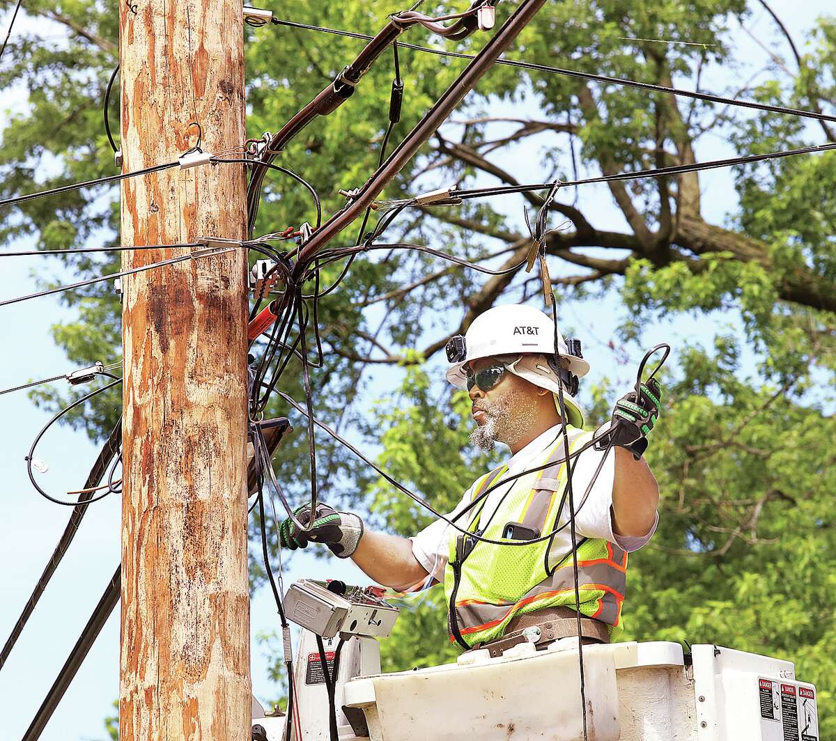 Ameren workers were not the only ones in action Friday morning. An AT&T lineman makes repairs in the 200 block of East 12th Street in Alton.