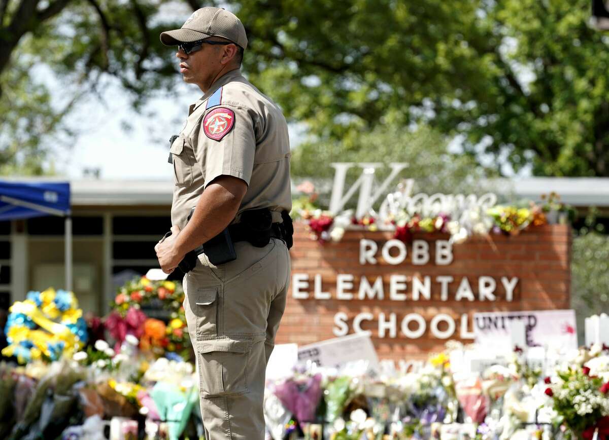 A police officer stands guard outside Robb Elementary School in the town of Uvalde, Texas, the United States, May 27, 2022. 