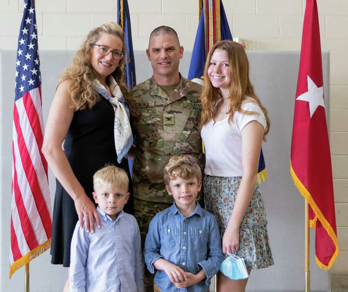 U.S. Army Lt. Col. Jeff Csoka, center, commander of the 106th Regiment of the Regional Training Institute of the New York Army National Guard, poses with his family during a ceremony at Camp Smith, N.Y., on May. 15.