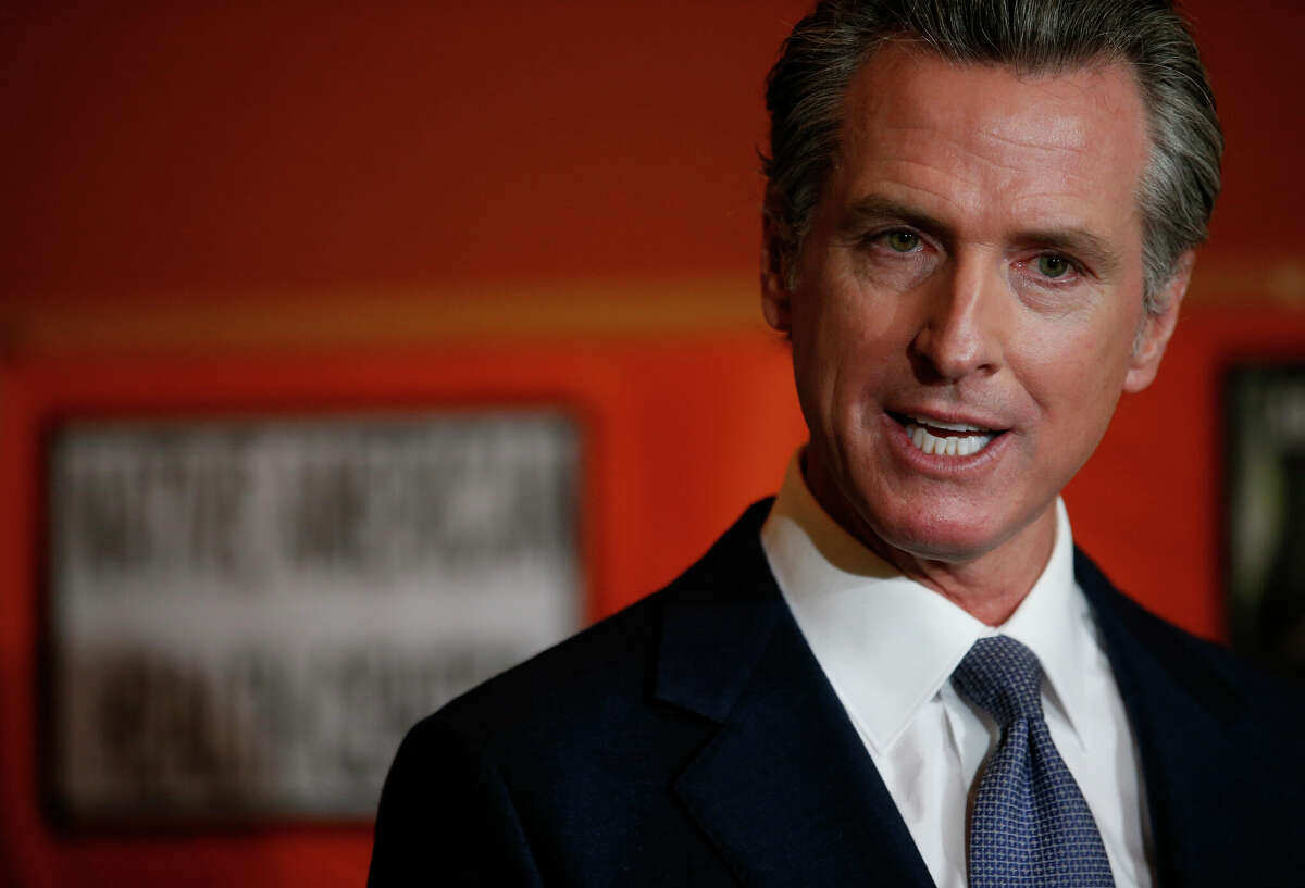 FILE: Gov. Gavin Newsom speaks during a press conference at the Native American Health Center in Oakland on Dec. 22, 2021. In an ad that will soon be running in Florida, Newsom urges people living in that state to join California in fighting back against what he sees as Republican extremism. 