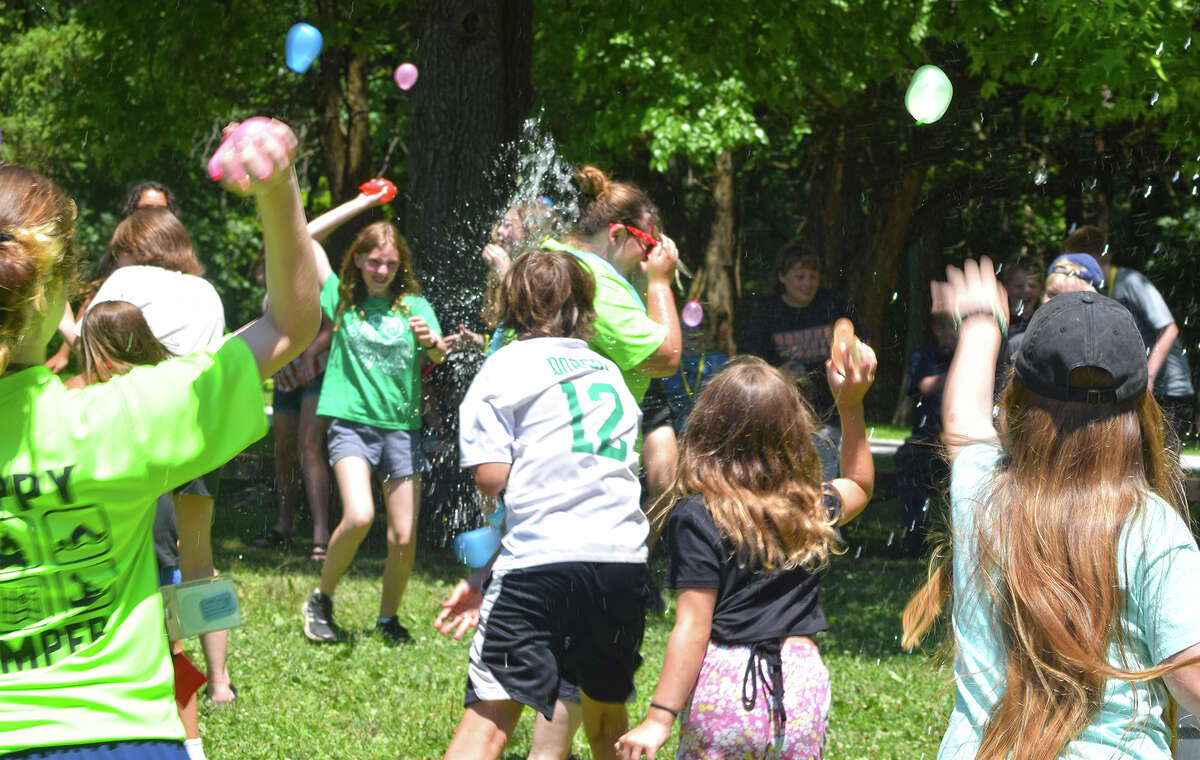 Western Illinois Youth Camp participants surprise camp director Allie Dolen on Friday with a barrage of water balloons to celebrate her birthday. The Jacksonville camp is offering eight weeks of programs this summer.