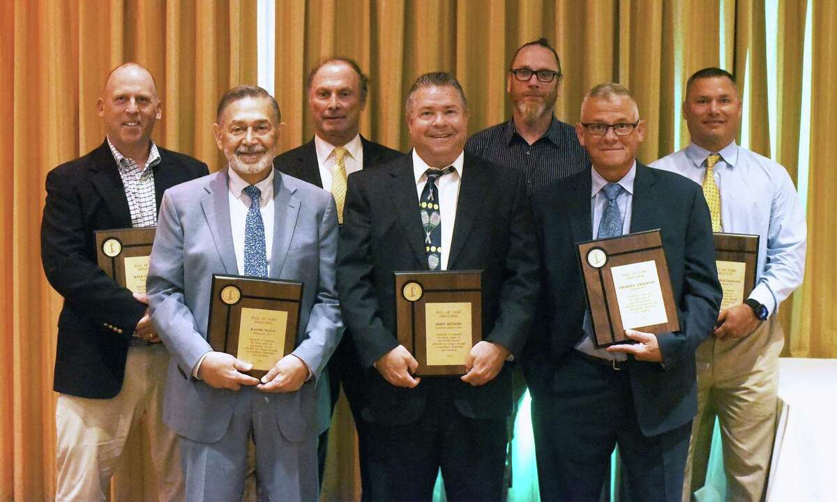 Honorees at the FCIAC’s Annual Recognition Program in Norwalk on Thursday included, from left, front row, Hall of Fame inductees Ralph Mayo, John Reisert and Charlie Anderson; back row, Hall of Fame inductees Kyle Seaburg and Tim Eagen; Jerry McDougall, Jr., who accepted the John Kuczo Award for his father; and Hall of Fame inductee Jason Shaughnessey.