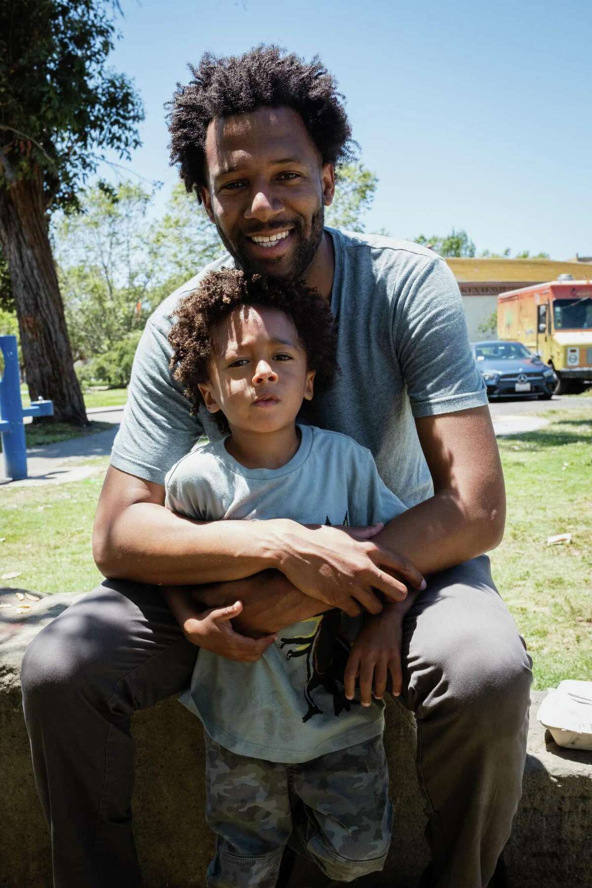 Theo Ellington with his son, Lennox, during the Black Dads of the Bay meetup in Oakland. Ellington was one of the 150 fathers who attended the inaugural event in 2020. He helped organizer Louis Ceaser organize the 2022 meetup.
