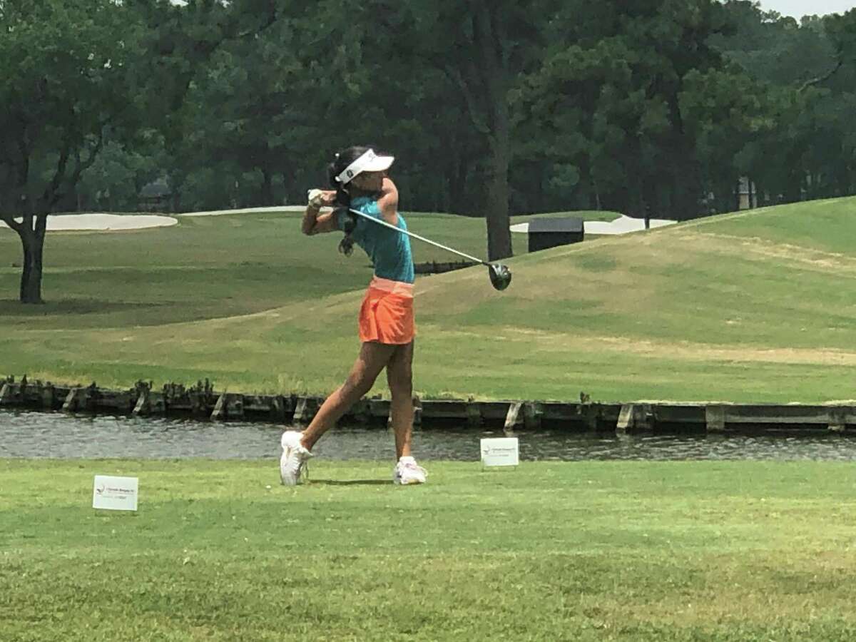 Kingwood's Bella Flores tees off at hole number one at the Kingwood Country Club.