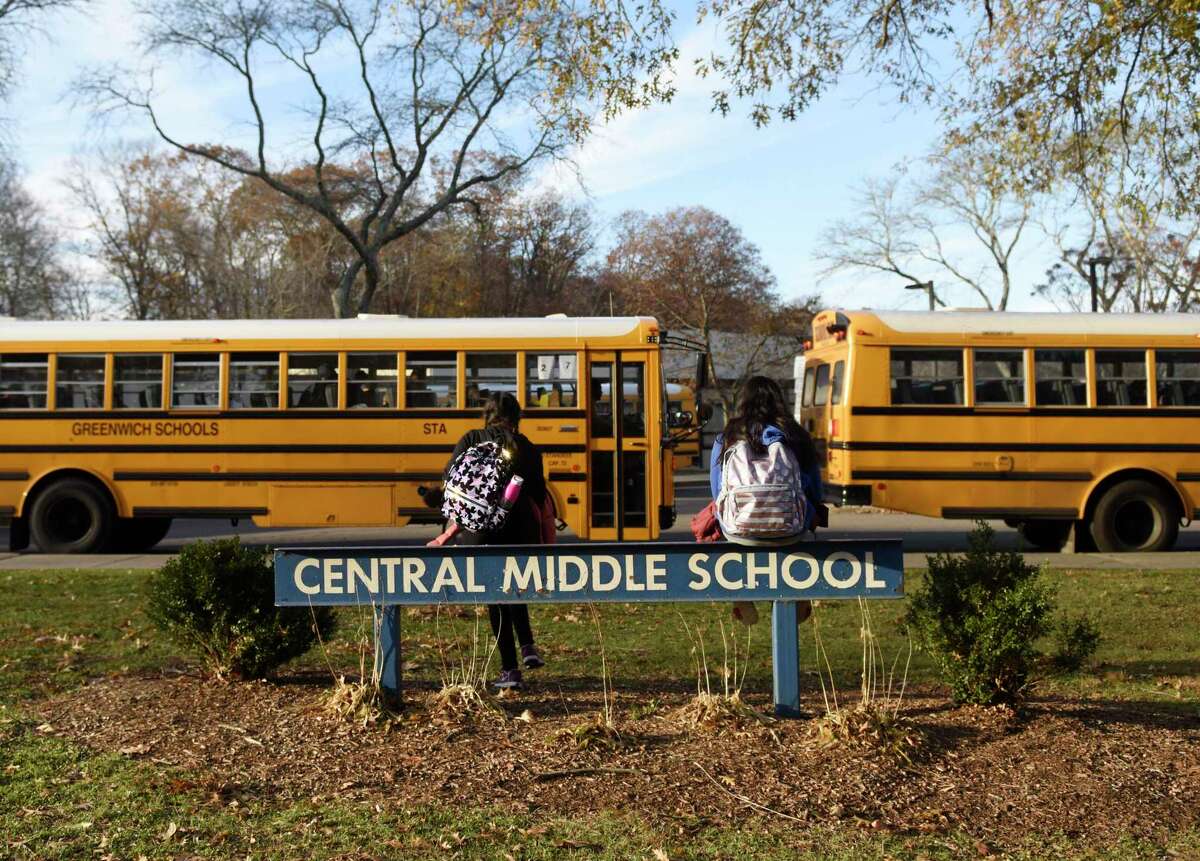 Students wait to be picked up at dismissal at Central Middle School in Greenwich, Conn. Thursday, Nov. 21, 2019.